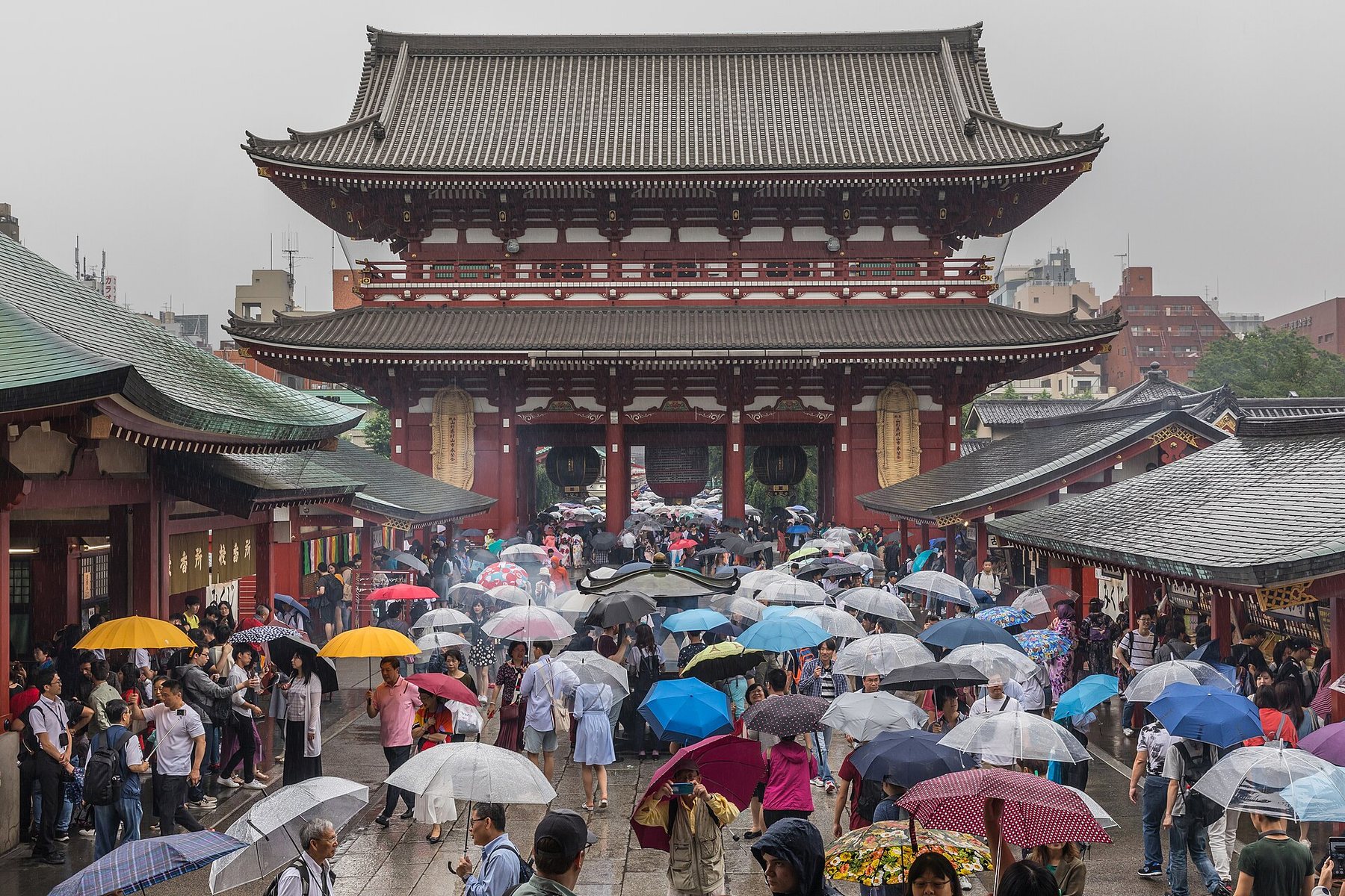 Visitors with umbrellas approaching the Hozomon gate at Senso-ji, photographed in June 2019